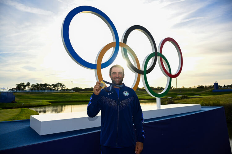 SAINT-QUENTIN-EN-YVELINES, FRANCE - AUGUST 04: Scottie Scheffler of Team USA poses by the Olympic rings with his gold medal after the final round of the 2024 Paris Olympics at Le Golf National on August 4, 2024 in Saint-Quentin-en-Yvelines, Ile-de-France. (Photo by Ben Jared/PGA TOUR/IGF)